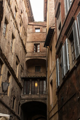 narrow street and old houses in Siena