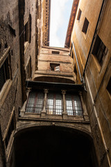 narrow street and old houses in Siena