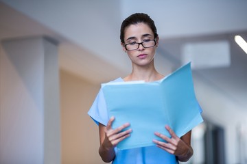 Female surgeon reading medical report