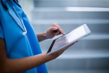 Female surgeon using digital tablet