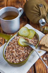 Military food with porridge and tea on old wooden boards close-up