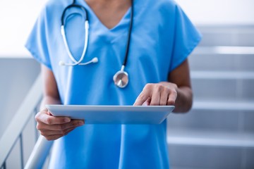 Female surgeon using digital tablet