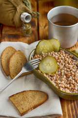 Military food with porridge and tea on old wooden boards close-up