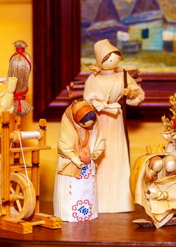 folk style traditional handmade figures made from natural materials doing chores and crafts.