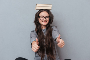 Asian woman with books on head