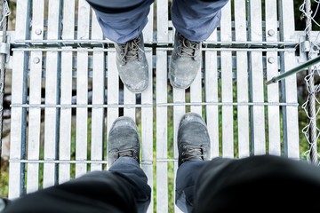 Feet Couple Man and Women in love hiking outdoor Lifestyle Travel and relationship concept river and stones on background top view..