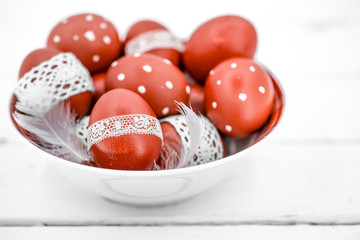 Red Easter eggs on a white plate