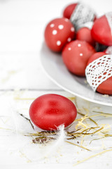 Red Easter eggs on a white plate