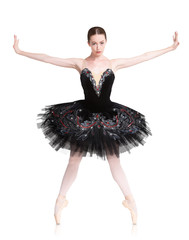 Beautiful ballerine stands in releve ballet position