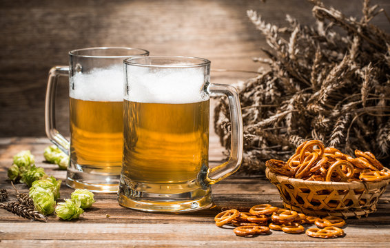 Photo of couple beers with pretzels, wheat spikes, hops