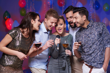 Group of friends doing karaoke show  .