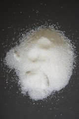 Obraz na płótnie Canvas White sugar scattered on the table.