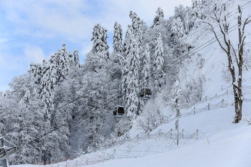 Cableway cabin ski lift on the winter mountain snowy background beautiful scenic landscape