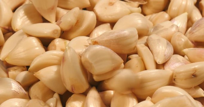Pouring peeled garlic