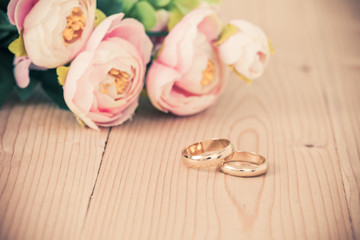 Wedding rings on wooden table