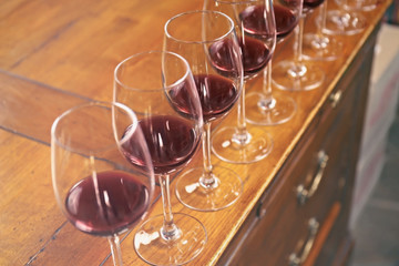 Row of glasses with red wine on bar counter