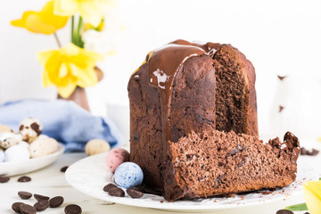 Easter orthodox sweet chocolate bread and colorful quail eggs on white background. Easter holidays...