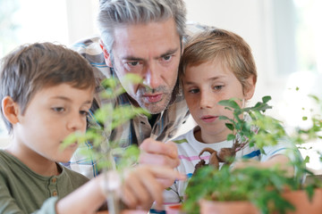 Teacher with kids in biology class learning about plants © goodluz