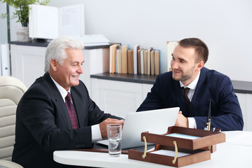 Young man with notary at office