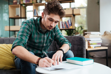 Man writing in notebook