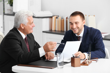 Young man with notary at office
