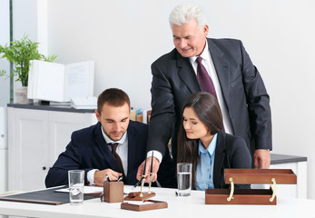 Young couple with notary at office