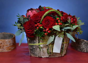 Bouquet of red roses in a box of birch bark