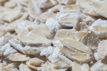 Oats scattered on the table. Bunting photographed in close-up.