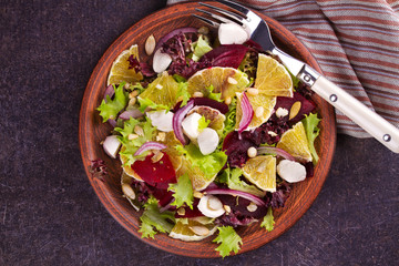 Mozzarella, Orange, Beetroot, Red Onion, Nuts and Seeds Salad. View from above, top studio shot