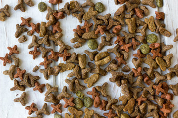 Pets food on white wooden table.