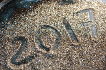 2017 new year concept. Numbers 2017 on the gold sand texture.