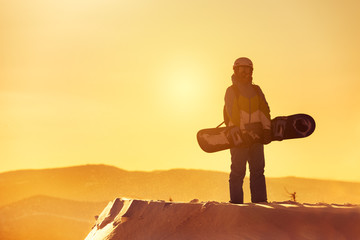 Snowboarder sunset summit stand snowboard ski