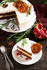 Piece of delicious chocolate cake with orange jam covered with cheese cream. Christmas dinner concept. Selective focus. Top view.