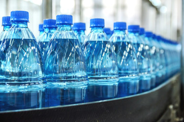 Closeup on mineral water bottles in raw and lines