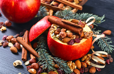 Red juicy apple with assorted nuts , raisins and cinnamon