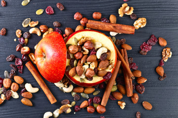 Red juicy apple with assorted nuts , raisins and cinnamon