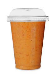 Tasty peach milkshake in plastic cup isolated on white