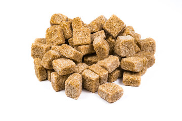 Pile of pieces of unrefined brown sugar isolated on white background