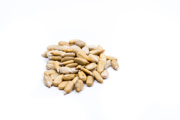 Closeup of a pile of peeled sunflower seeds isolated on white background