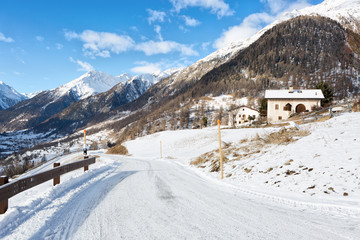 Fototapeta na wymiar Country road in the beautiful sunny morning, Guarda, Lower Engadine, Graubunden; Switzerland