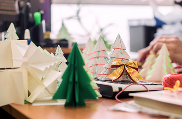 Making origami Christmas trees in the office