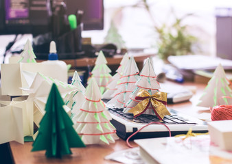 Making origami Christmas trees in the office