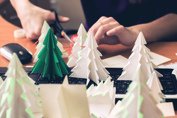 Making origami Christmas trees in the office