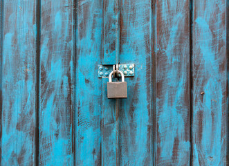 Close up of an antique wooden door painted in blue