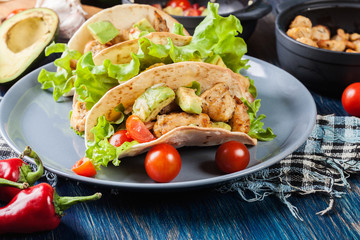 Authentic mexican tacos with chicken and salsa with avocado, tomatoes and chillies