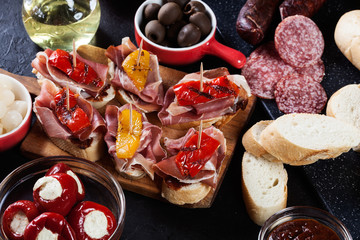 Spanish tapas with slices jamon serrano and grilled pepper. Also