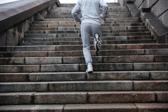 Back view of man running on stairs