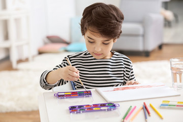 Cute little boy painting
