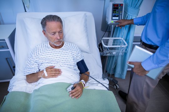 Doctor Examining Heart Rate Of Patient