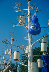 Trees on the seaboard decorated with lamps.